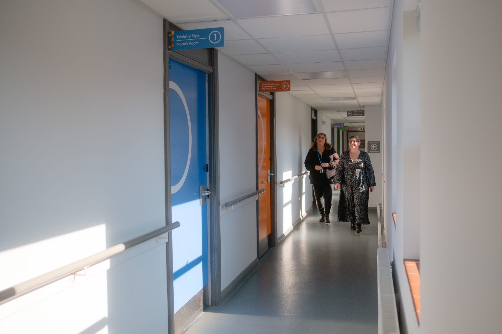 Image of two members of Staff in Ward with Dementia Friendly Signage