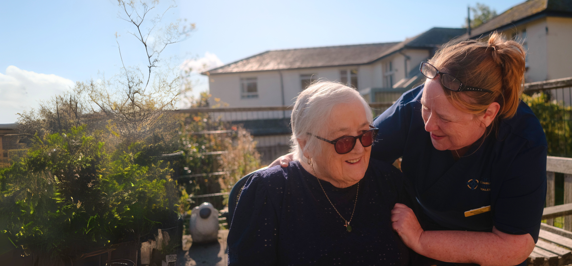 Member of Powys Teaching Health board Staff with arm around patient.